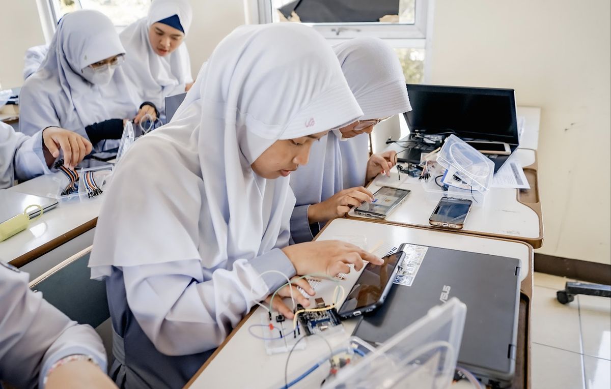 Indonesian students working with Arduino on mobile