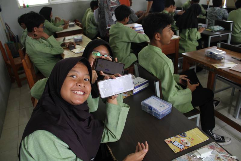 Smiling student with coding app